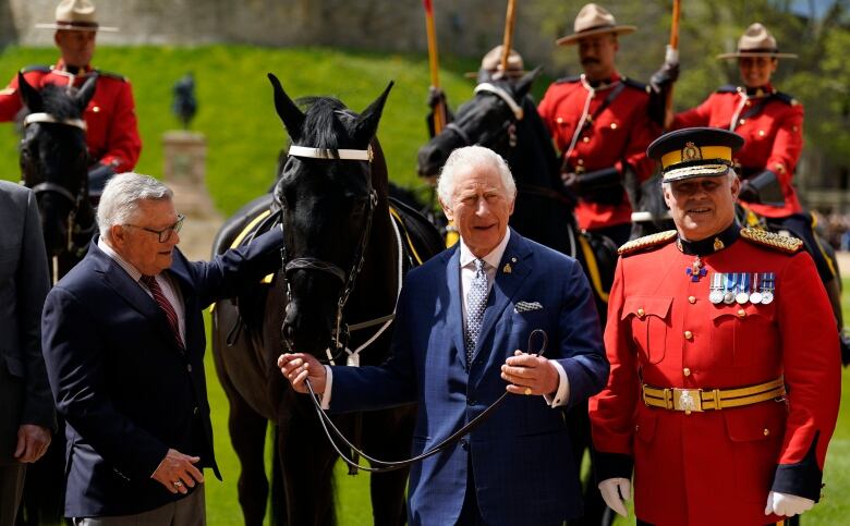 King Charles is pictured with a horse gifted to him by the RCMP.