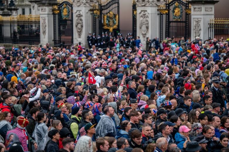 A crowd outside a gate.