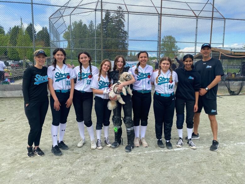 Amaya Cruz, third from left, is being honoured as a mental health advocate for youth by the City of Richmond. She says playing softball helps manager her anxiety and depression.