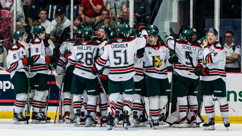 Hockey players in Mooseheads jerseys celebrate on the ice.