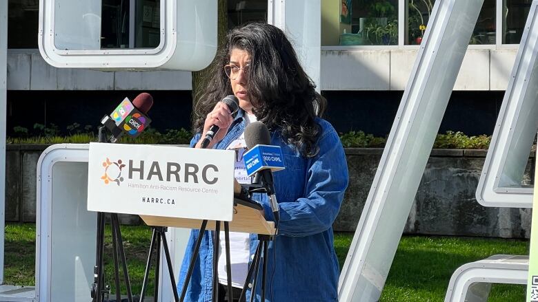 A person speaking at a podium.