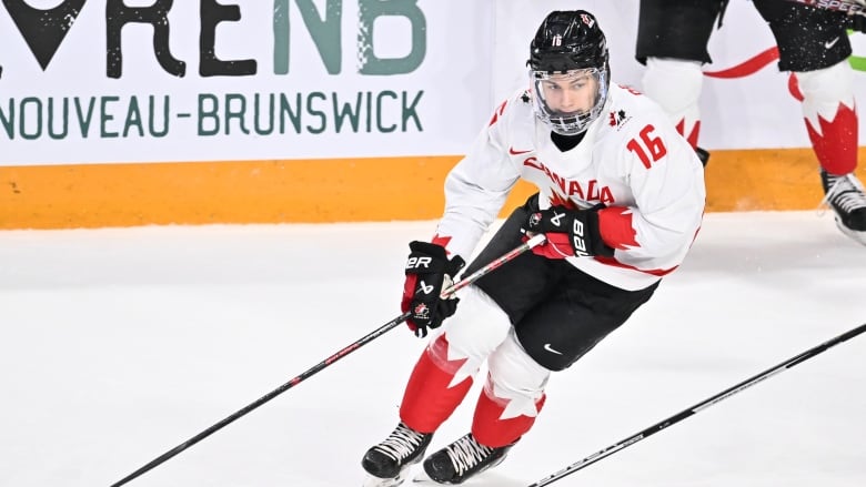 A hockey player is seen controlling the puck mid-game.