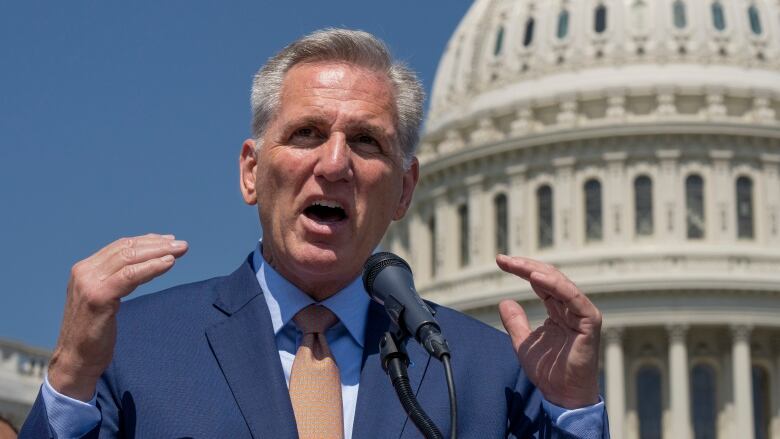 Kevin McCarthy stands in front of the Capitol building.