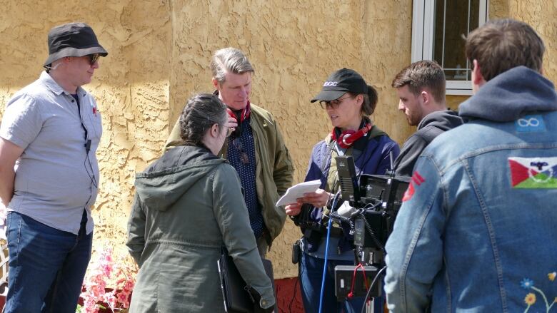 A film crew goes over scene shot plans. 