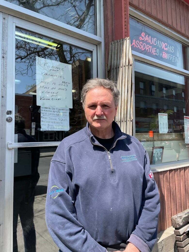 Man in front of a restaurant.