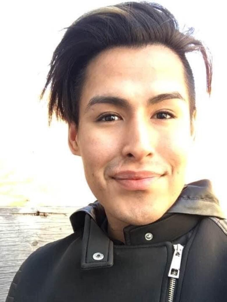 Portrait of smiling young man in smart jacket.