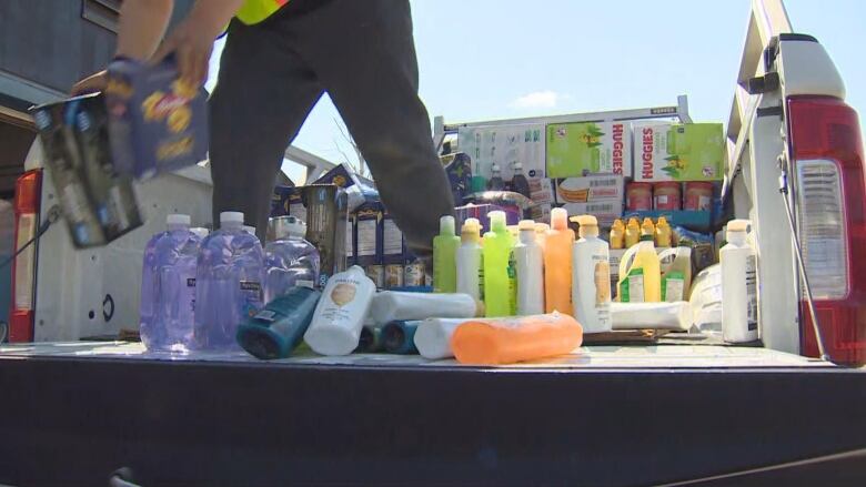 A person unloads items from a truck.