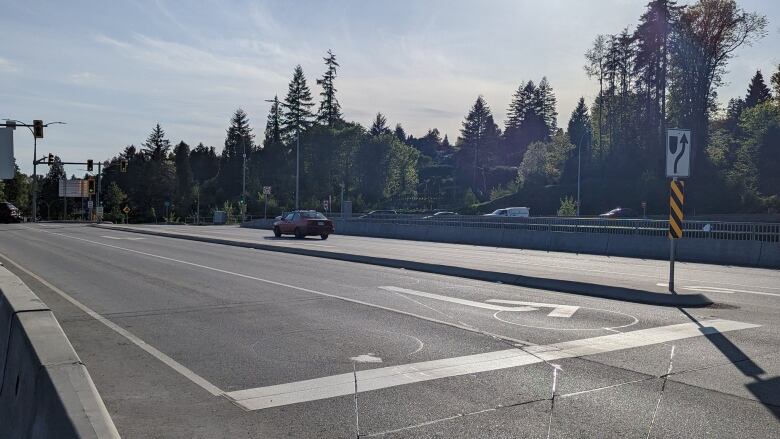 A picture of a highway overpass with trees beyond it.