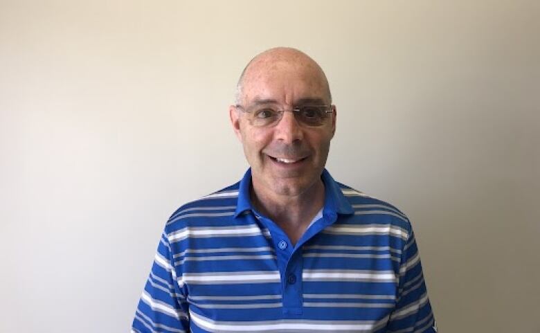 A headshot of a man smiling at the camera 