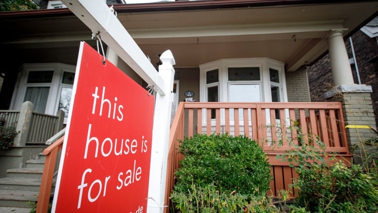 A for sale sign on a house in Toronto.