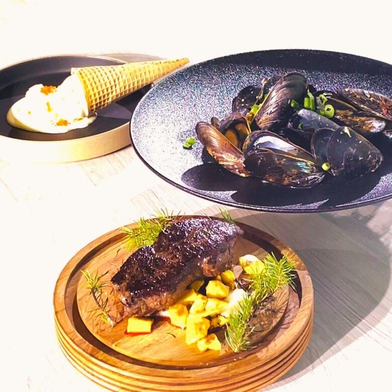 Featured in this photo are three dishes including pine-smoked elk, dachi mussels and salmon ice cream.