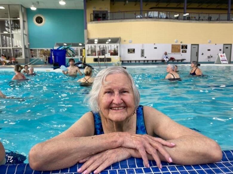 Barbara Edwards, 100, poses at the side of the pool at the South London Community Centre.