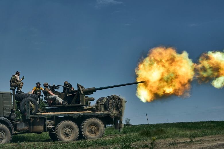 Ukrainian soldiers fire a cannon near Bakhmut, Ukraine.