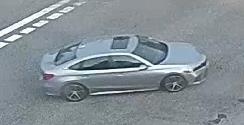 A grey sedan is seen in a surveillance photo still.