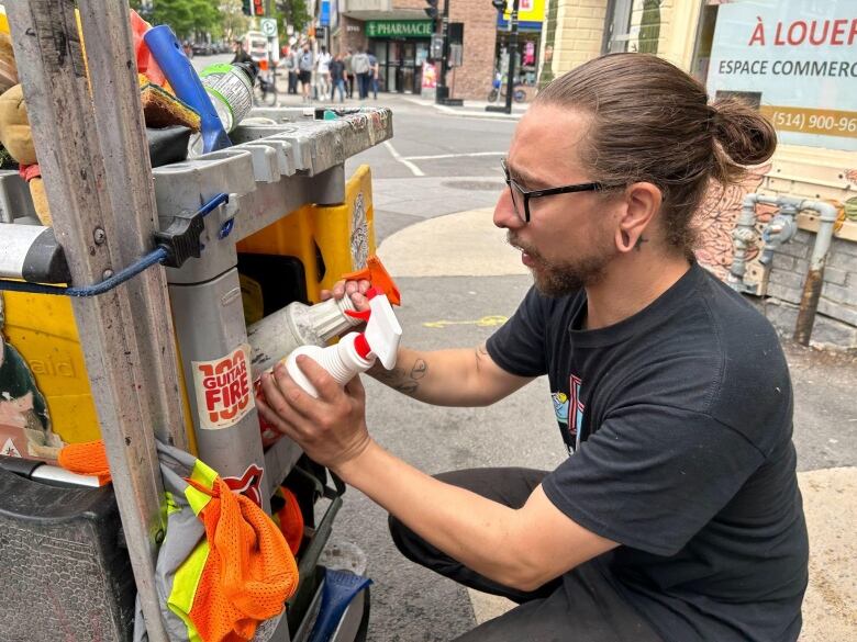 Marcel David picking up cleaning products from a cart