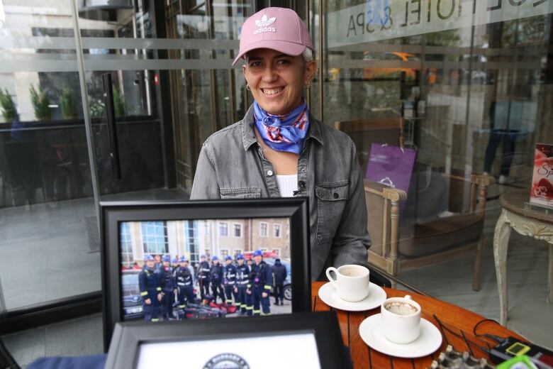 A person sits at a table in a cafe.