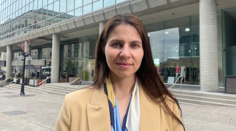 A woman in front of a building.