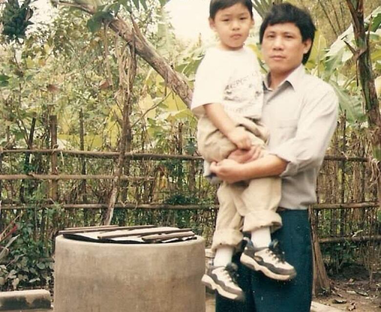 A man holding a boy in his arms.