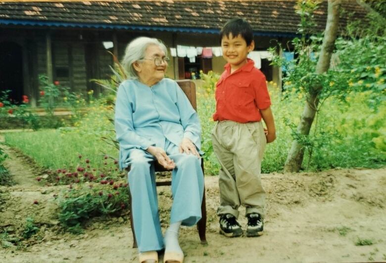 A young boy and an older woman in an old photo.