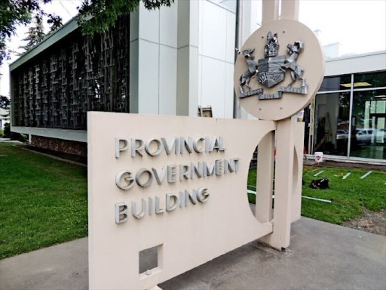 A Provincial Government Sign and Crest are situated in front of the courthouse in Quesnel, B.C. 