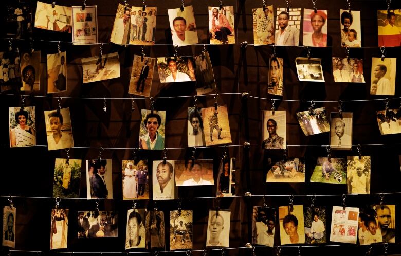 Rows of photographs hanging on wires