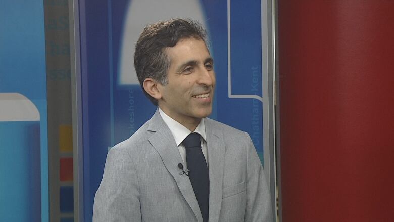 A man in a grey suit in the CBC Windsor studio. 