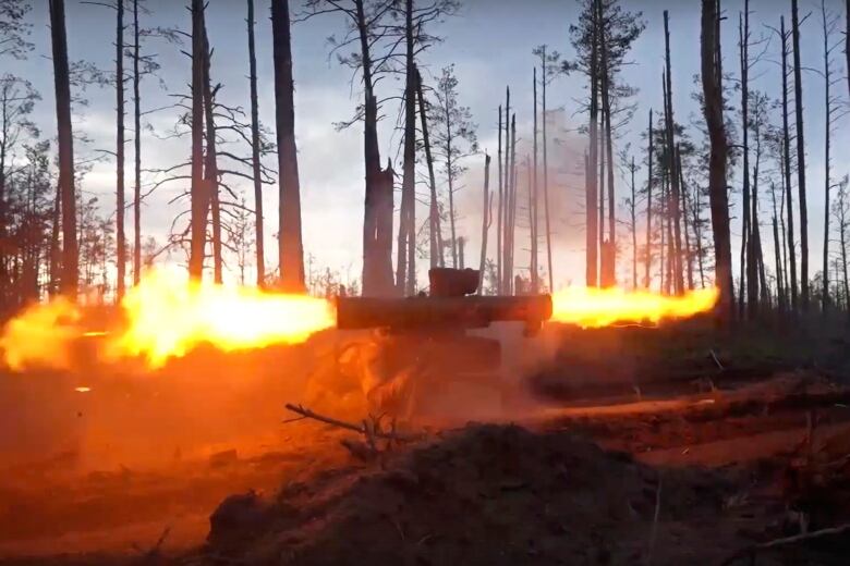 Fire is shown shooting out of a weapon on the ground.