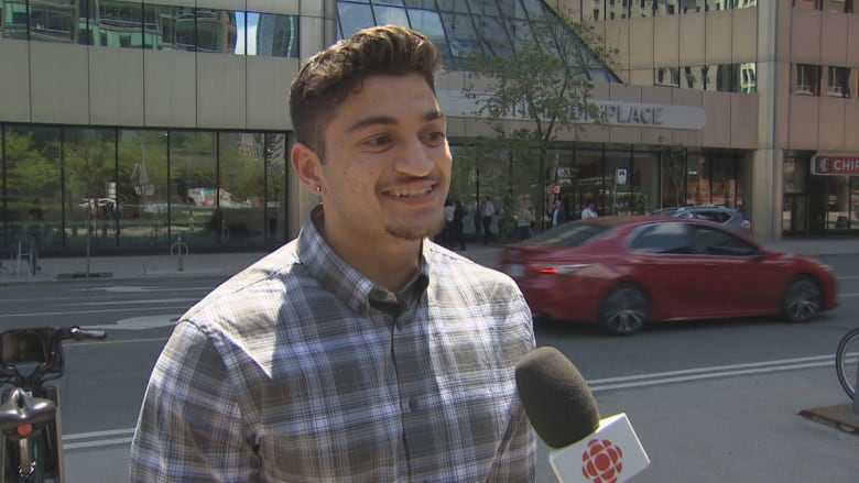 A man on the sidewalk answers a question from CBC News.