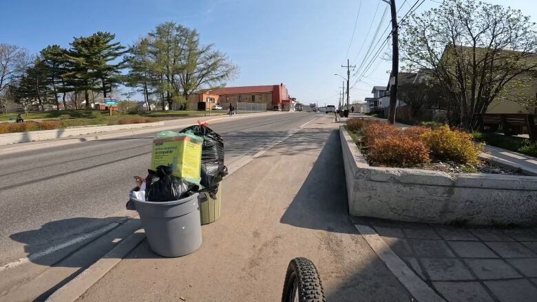 A pile of garbage left for curbside collection on the cycle track. 