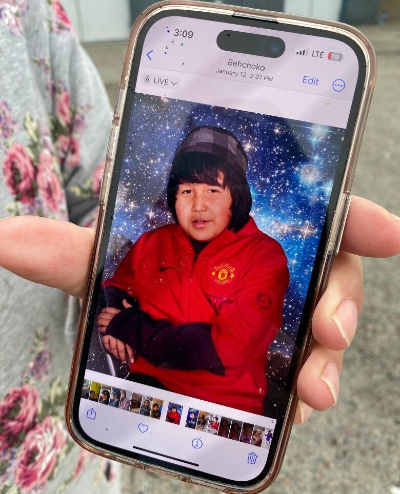 Portrait of young man on woman's phone. 