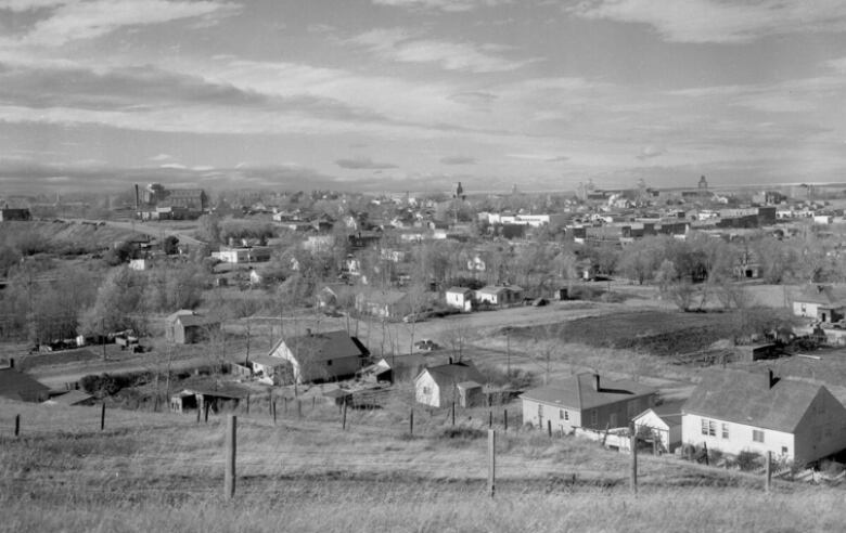 A black-and-white photo showing the town of Cardston in summer. 