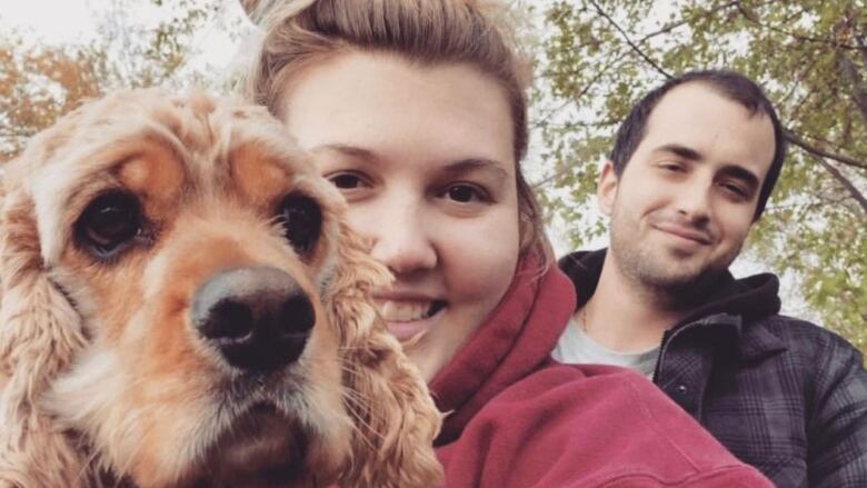 Two people and a dog.