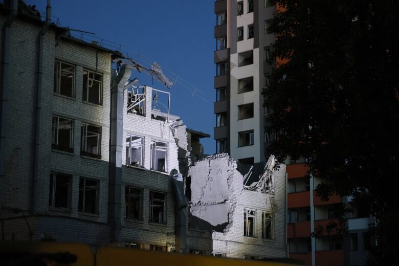 A large section of two floors is missing from a multi-storey building.