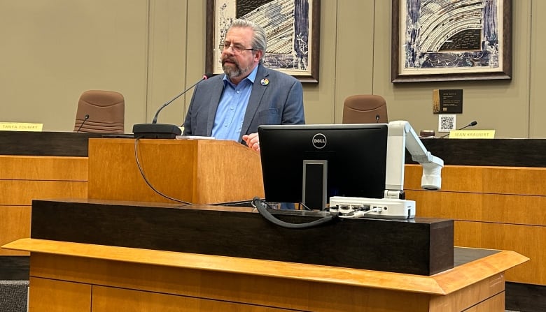 The mayor of Canmore at the podium in council chambers