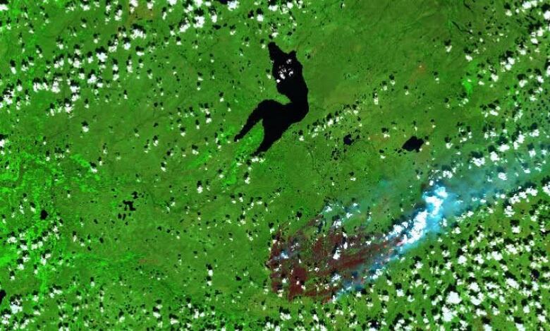 A satellite image shows Sambaa K'e and a nearby fire.