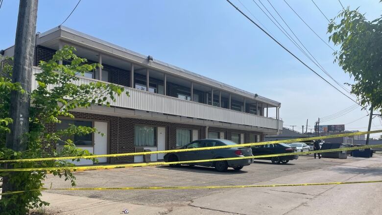 A motel is shown blocked off with police tape.