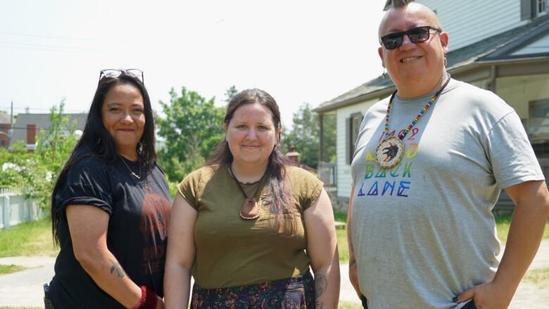 Three people smiling for a photo.