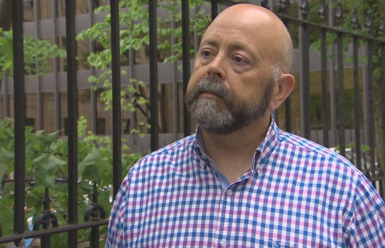 A man with a beard in a checked shirt.