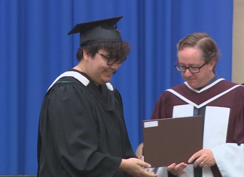 Bird prepares to receive his degree with a smile.