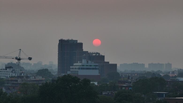 Smoke-filled sky over Toronto's west end is seen here in the evening on June 6, 2023.