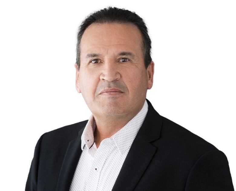 A headshot of a Cree man looking at the camera