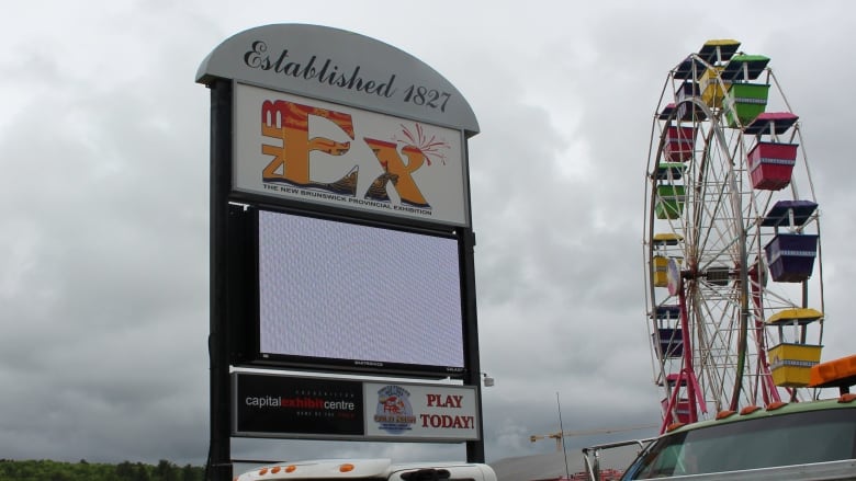 Trucks are parked outside the New Brunswick Provincial Exhibition in Fredericton.