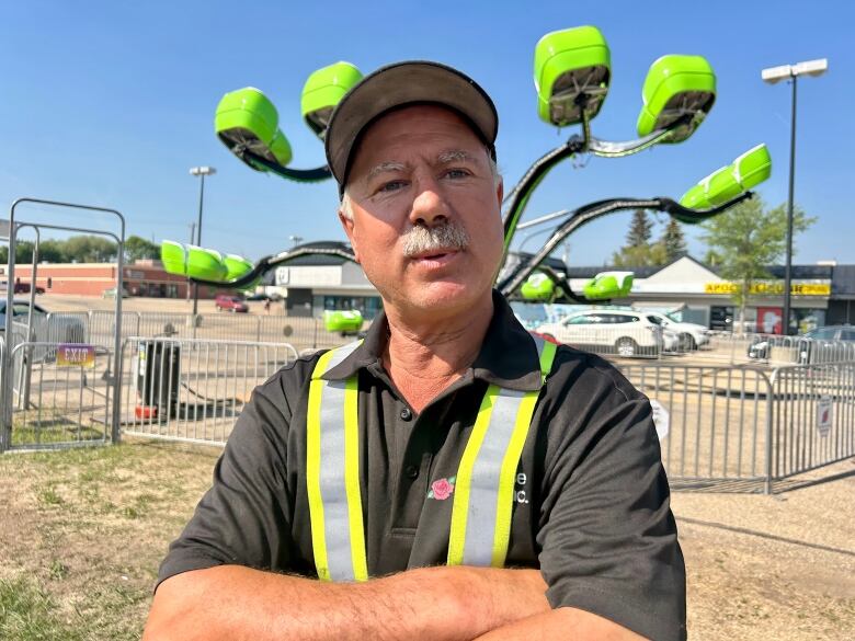 A man stands in front of a ride