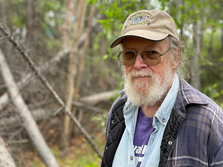 Bearded man in forest.