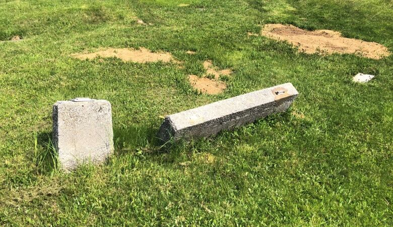 damaged headstones in a cemetery.