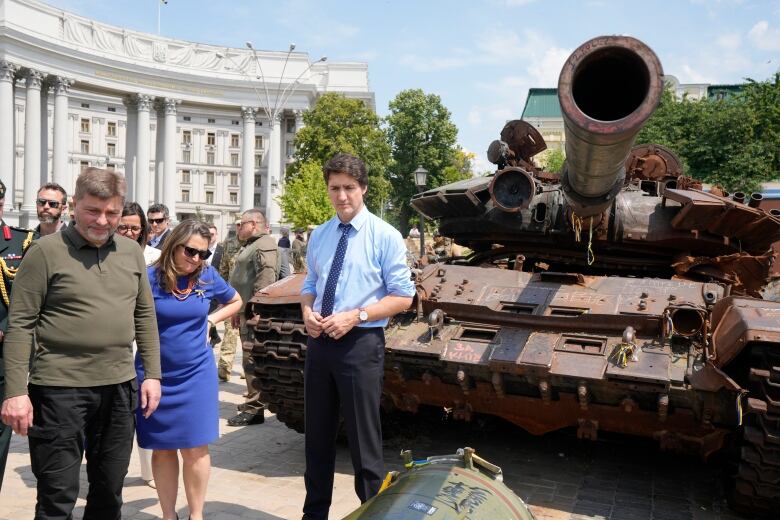 People surround tanks