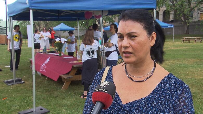 A woman speaks on camera.