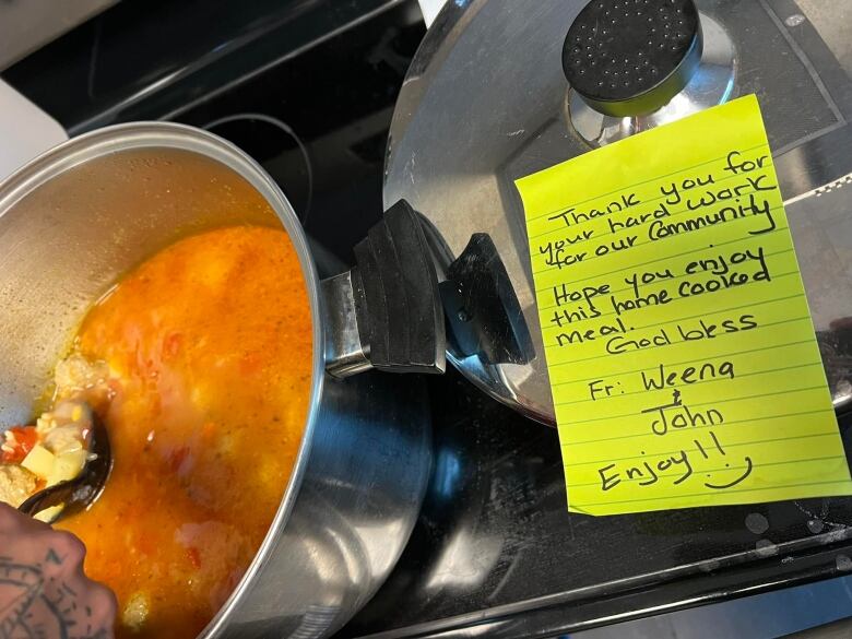 A stew in a pot with a note saying it is in thanks for keeping community safe during wildfires