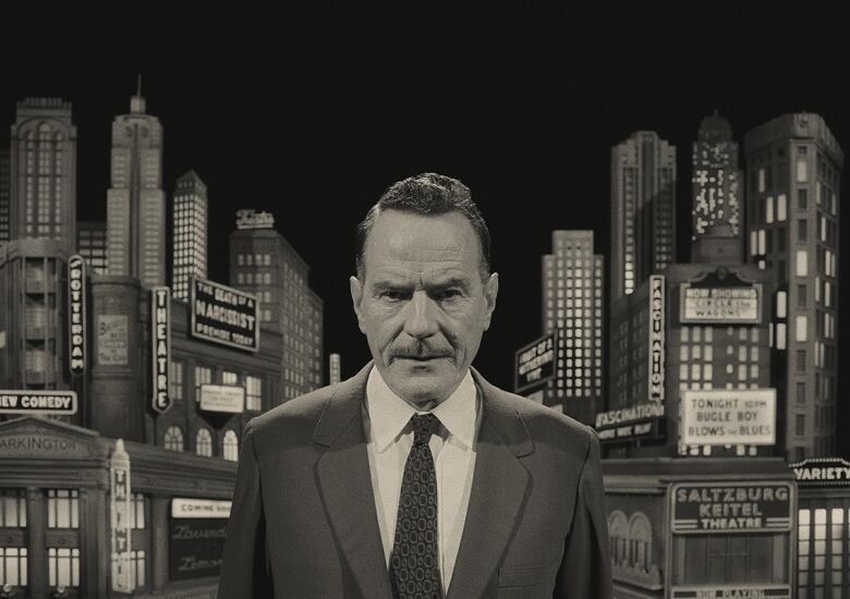 A black and white image of a man in a suit is shown, in front of a symmetrical model of a city behind him. Numerous signs are shown on the buildings, including 'The Death of a Narcissist.'