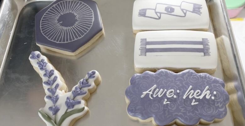 Becky Thomas, owner of Bex Baked Goods, displays a series of sugar cookies she baked that celebrate Haudenosaunee culture and language